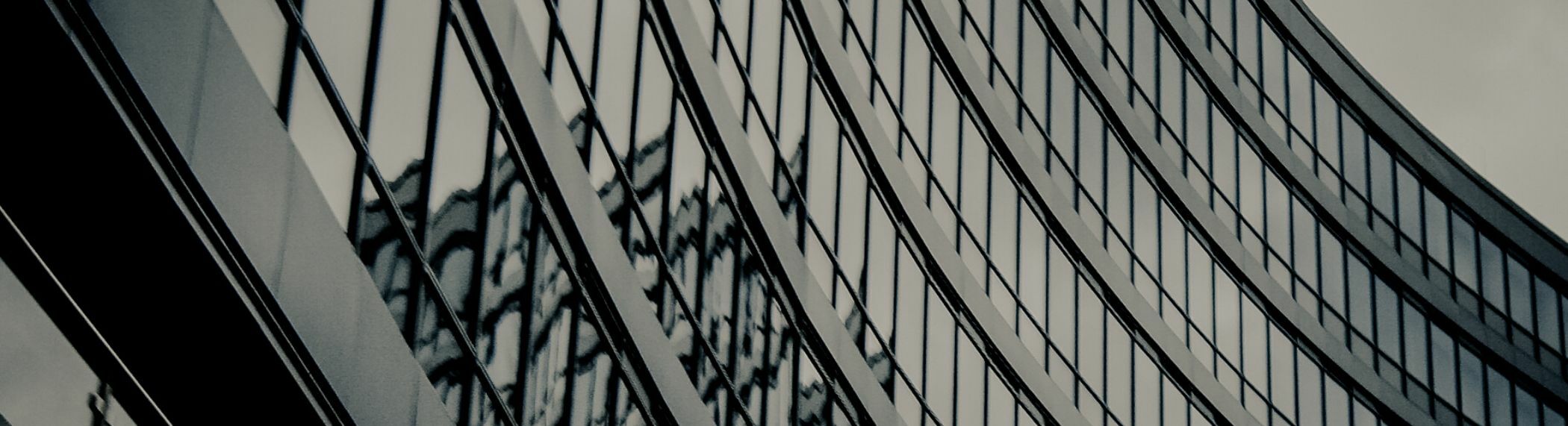 Rows of office windows with reflection of another building